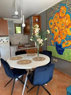 a kitchen with a table with a vase of flowers on it at Appartement centre avec garage privé in Budva