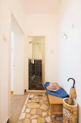 a bathroom with a table and a shower in a room at Apartment Srdanovic in Budva