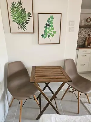 two chairs and a wooden table in a kitchen at Apartment Srdanovic in Budva