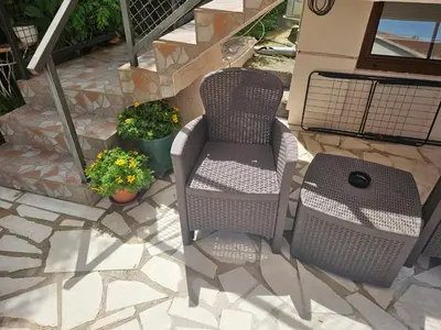 two chairs and a table on a patio at Apartment Srdanovic in Budva