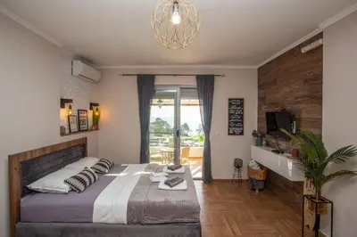 a bedroom with a bed and a potted plant at Apartments Bogojevic in Ulcinj
