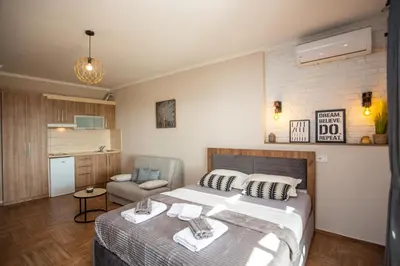 a bedroom with a bed and a chair in it at Apartments Bogojevic in Ulcinj