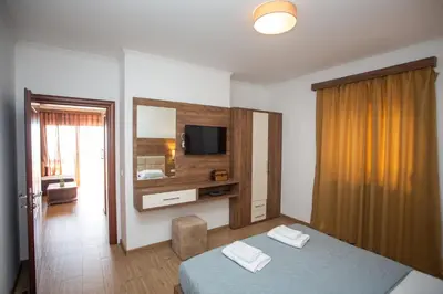 a hotel room with a bed and a television at Apartments Bogojevic in Ulcinj