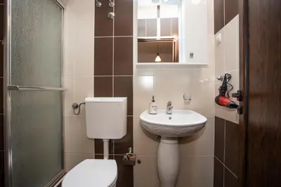 a small bathroom with a toilet and a sink at Apartments Bogojevic in Ulcinj