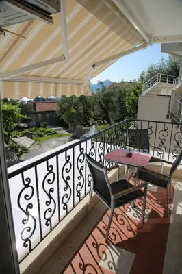 a patio with a table and chairs on a balcony at Apartment Mia in Sveti Stefan