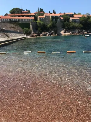 a body of water with several buoys in the water at Apartment Mia in Sveti Stefan