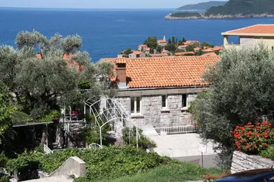 a building with a view of the ocean at Apartment Mia in Sveti Stefan