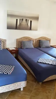two beds in a room with a bridge at Apartments Music in Sutomore