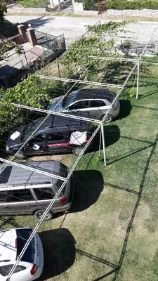 a couple of cars parked in the grass at Apartments Music in Sutomore