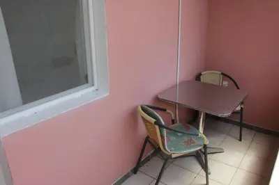 a table and chairs in a room with a window at Apartments Sunpoint in Ulcinj