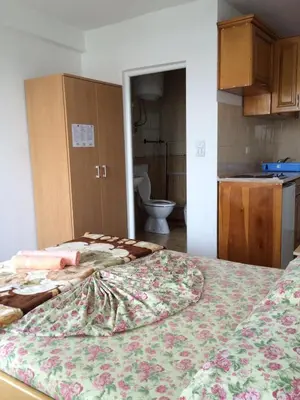 a bedroom with a bed and a bathroom with a toilet at Sand and Sea Apartments in Ulcinj