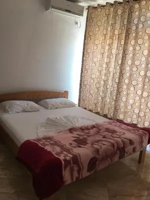 a bed in a bedroom next to a window at Sand and Sea Apartments in Ulcinj