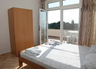 a bedroom with a bed and a large window at Sand and Sea Apartments in Ulcinj