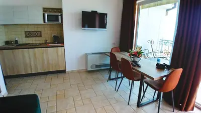 a kitchen and dining room with a table and chairs at Villa Edelweiss in Sveti Stefan