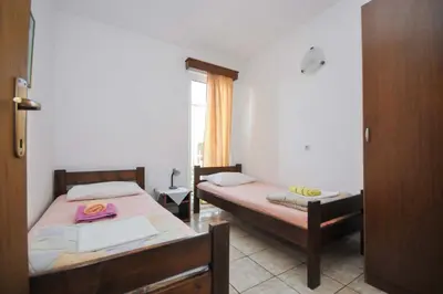 a bedroom with two beds and a window at Apartments Milos Kaladjurdjevic in Budva