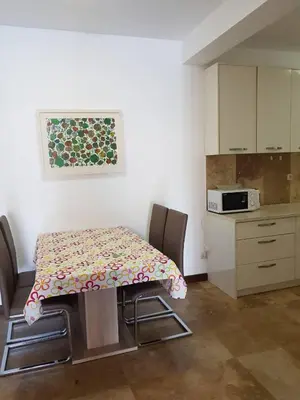 a kitchen with a table and two chairs and a counter at Luxury Apartments Trend in Budva