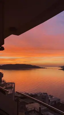 a view of a sunset over a body of water at Luxury Apartments Trend in Budva