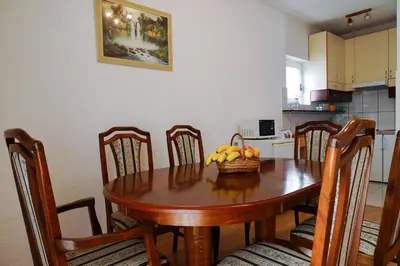 a dining room table with a bowl of fruit on it at Guest House Heart of Budva in Budva