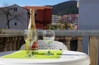 a bottle of champagne and two glasses on a table at Guest House Heart of Budva in Budva
