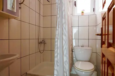 a bathroom with a toilet and a sink and a tub at Guest House Heart of Budva in Budva