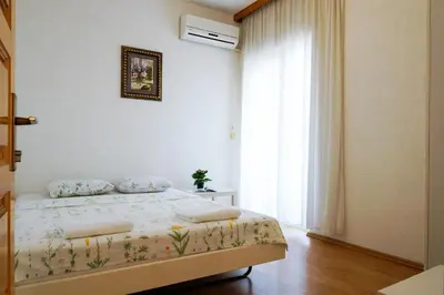 a bedroom with a bed and a large window at Guest House Heart of Budva in Budva