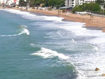 a view of a beach with a wave in the water at Malibu Apartments in Sutomore