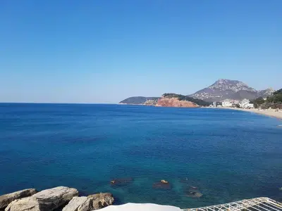 a view of a beach with blue water and rocks at Malibu Apartments in Sutomore