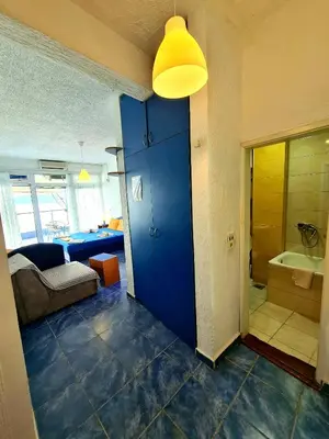 a blue door in a room with a bathroom at Malibu Apartments in Sutomore