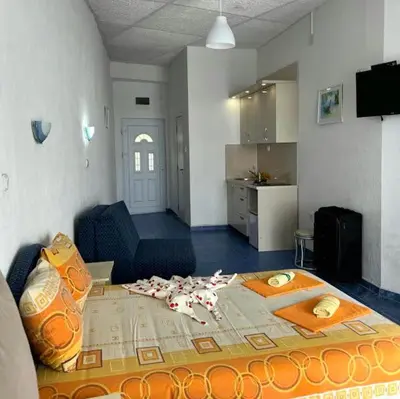 a living room with a table with fallen petals on it at Malibu Apartments in Sutomore