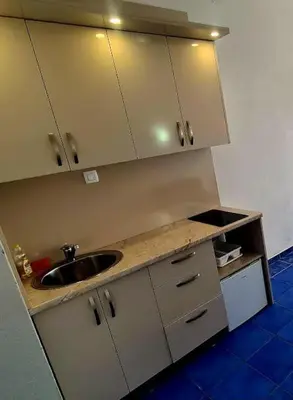 a kitchen with a sink and a counter top at Malibu Apartments in Sutomore