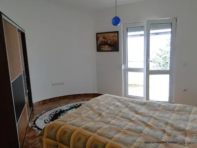a bedroom with a bed and a window at Holiday Home Mikki in Dobra Voda