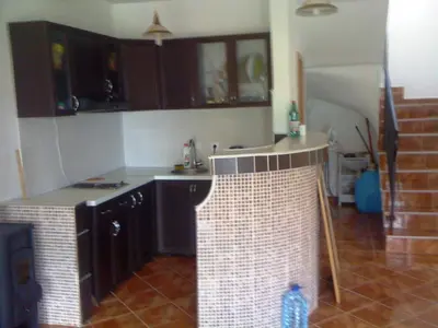 a kitchen with black cabinets and a tile floor at Holiday Home Mikki in Dobra Voda