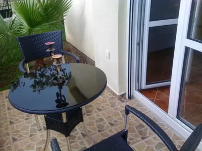 a blue table and chairs on a patio at Holiday Home Mikki in Dobra Voda