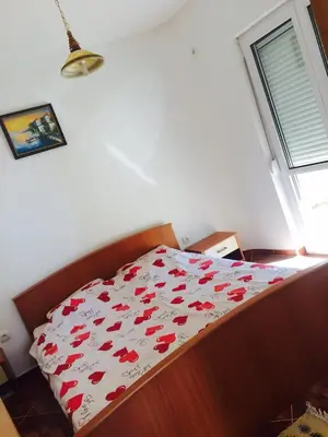 a bedroom with a bed with red hearts on it at Holiday Home Mikki in Dobra Voda