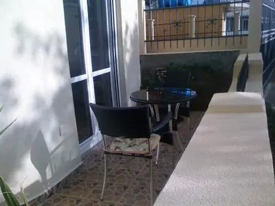 a patio with a table and chairs and a balcony at Holiday Home Mikki in Dobra Voda
