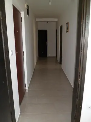 a hallway with white walls and a tile floor at Milocer Apartment in Sveti Stefan