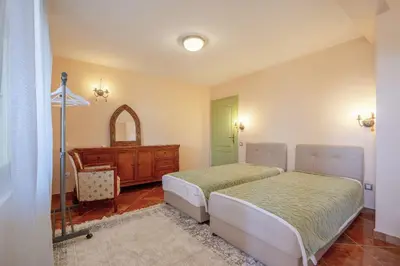 a bedroom with two beds and a dresser at Maroccana in Dobra Voda