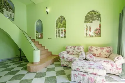 a living room with a couch and a staircase at Maroccana in Dobra Voda