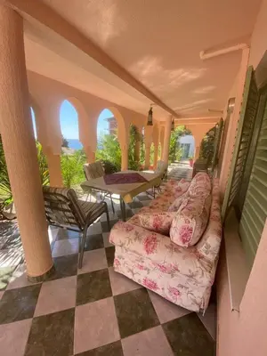 a living room with a couch and a table at Maroccana in Dobra Voda
