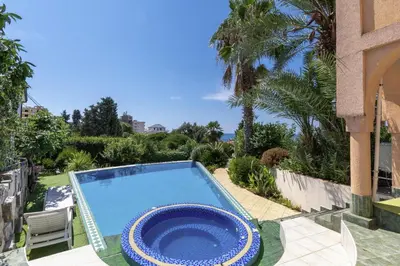 a large swimming pool sitting next to a house at Maroccana in Dobra Voda