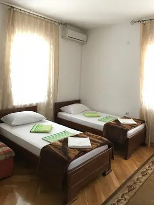 a room with two beds and a window at Apartments Old Olive in Bar