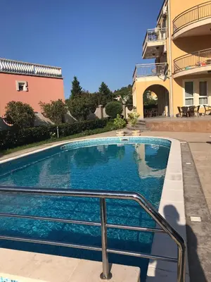 a swimming pool in front of a house at Vila Laguna in Sutomore