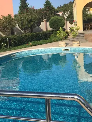 a large swimming pool with blue water at Vila Laguna in Sutomore