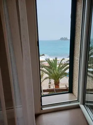 a window view of the beach from a hotel room at Apartments Adria in Petrovac na Moru