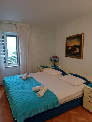 a bedroom with a large bed with towels on it at Apartments Adria in Petrovac na Moru