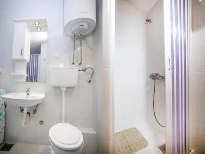 a bathroom with a toilet and a sink and a shower at Apartments Adria in Petrovac na Moru