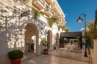 a building with a patio with tables and chairs at Hotel Moskva in Budva