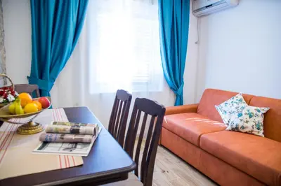 a living room with a couch and a table at Guest House S-Lux in Petrovac na Moru