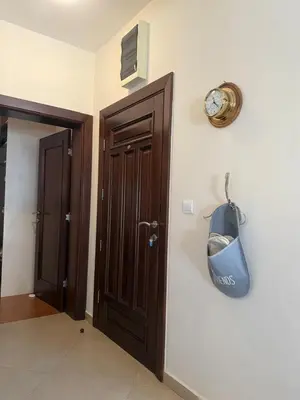a room with a door with a clock and a purse on the wall at Apartment Benvenuti in Kotor