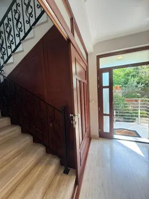 a hallway with a wooden door and a staircase at Apartment Benvenuti in Kotor